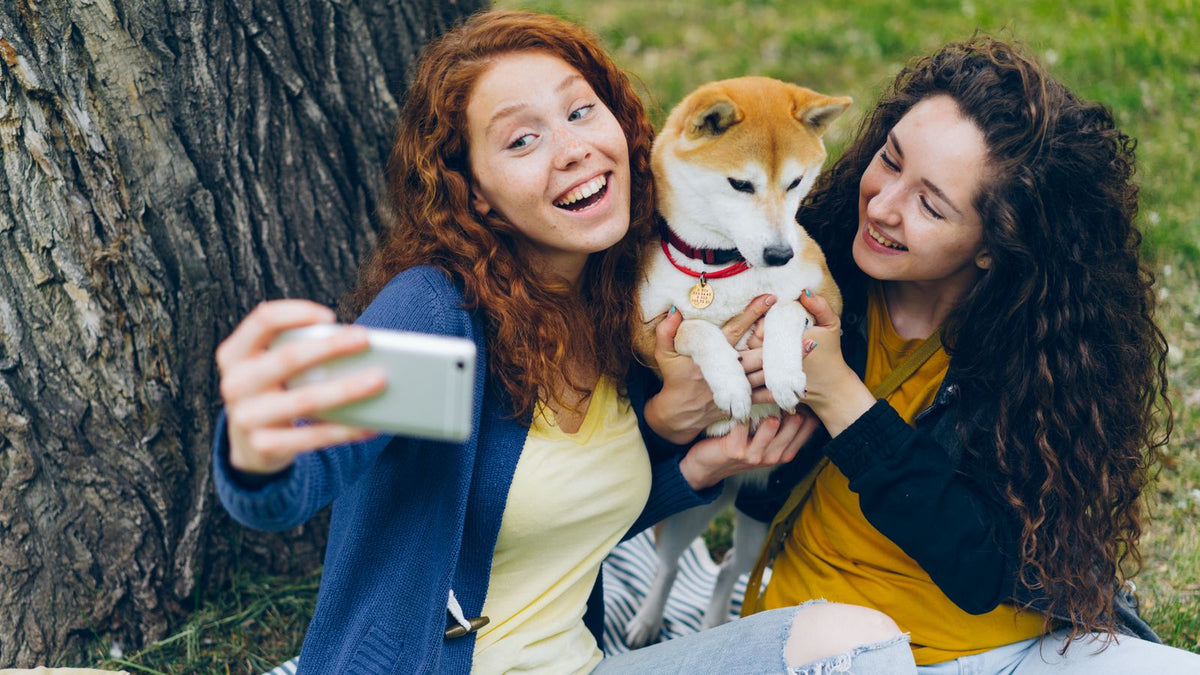 People taking a selfie with their dog, relevant to dog hashtags for Instagram