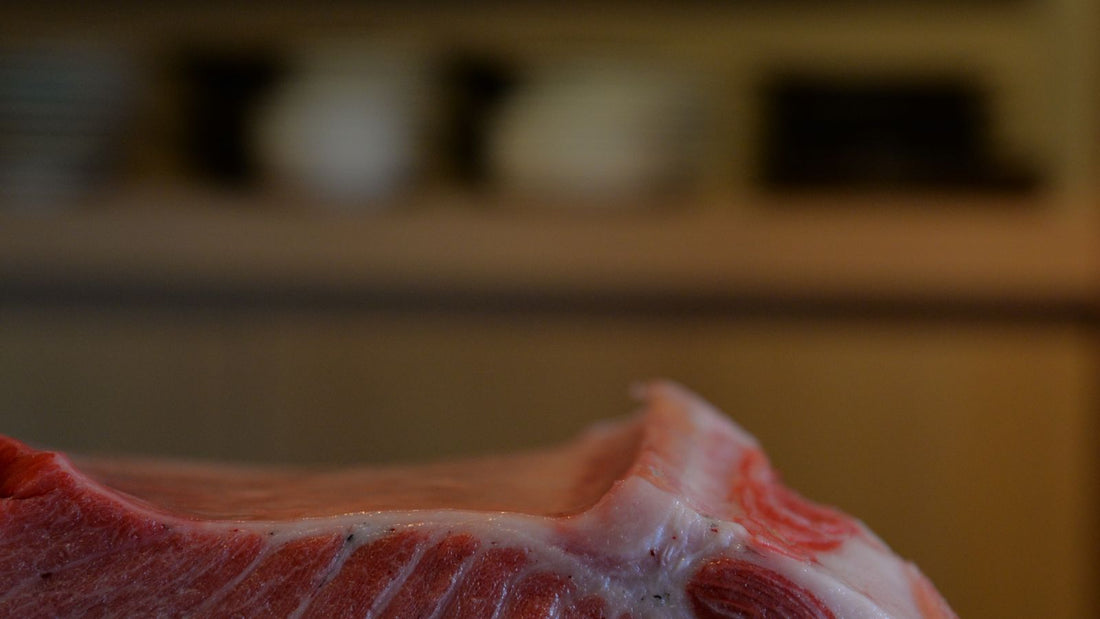 Fresh tuna steak at a fish market, relevant to whether dogs can eat tuna