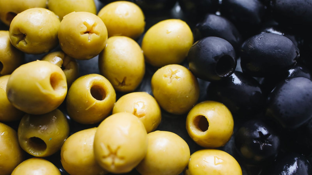 Close-up of green and black olives, relevant to whether dogs can eat olives