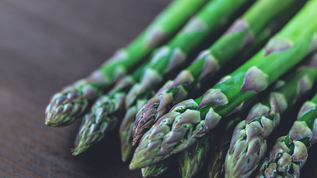 Fresh green asparagus spears on a wooden table