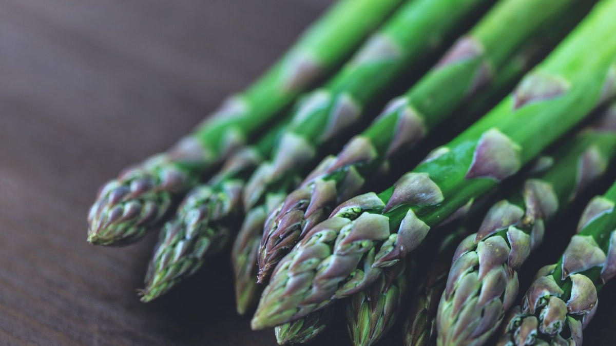 Fresh green asparagus spears on a wooden table