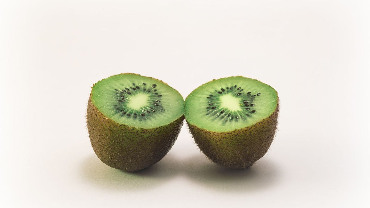 Fresh sliced kiwi halves showing vibrant green flesh and seeds