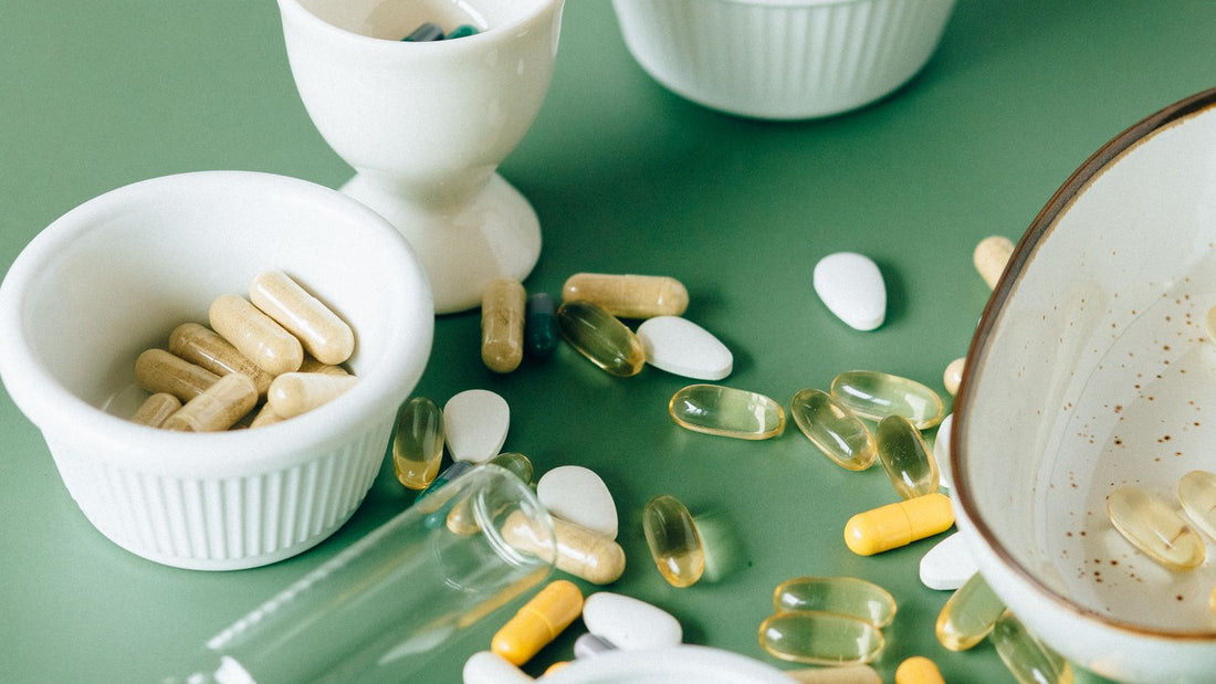 Assorted supplement capsules and tablets in bowls
