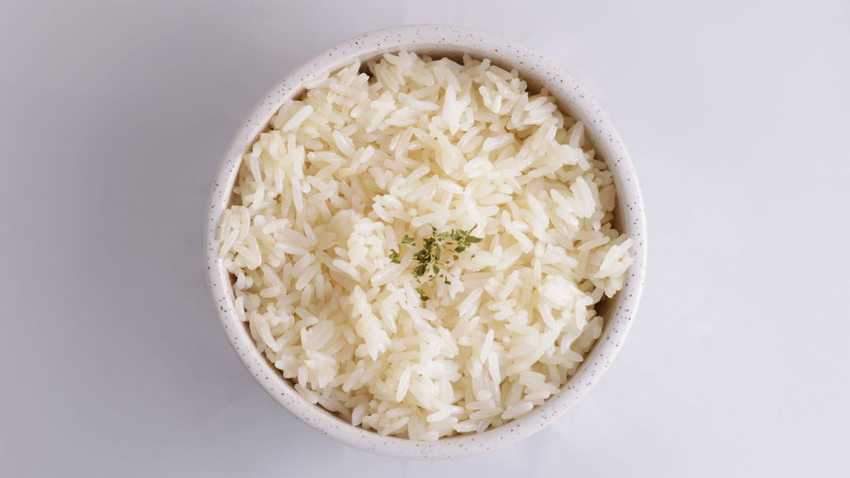 Bowl of plain cooked white rice, safe for dogs in moderation
